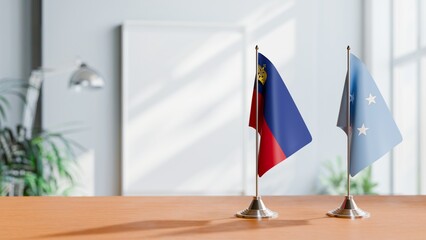 FLAGS OF LIECHTENSTEIN AND MICRONESIA ON TABLE