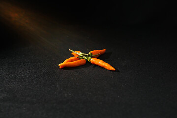 chili peppers on a black background