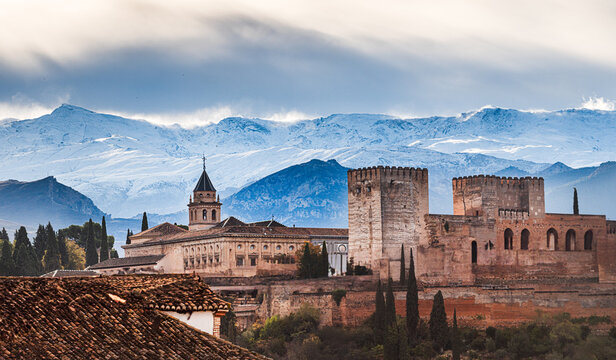 Snowy Sierra Nevada in early winter with Pico de Veleta behind the warm colored Alhambra, UNESCO World Heritage Site, Granada, Andalusia, Spain