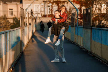 Cheerful Couple Enjoying a Romantic Moment on a Sunlit Bridge