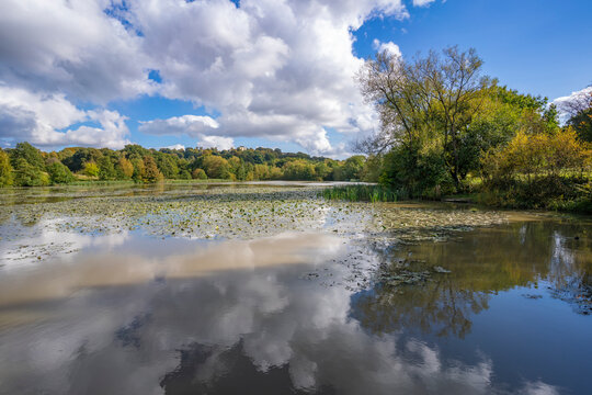 View of dramatic clouds refecting in Hardwick Ponds, Hardwick Park, Hardwick Hall, Bolsover, Derbyshire, England, United Kingdom