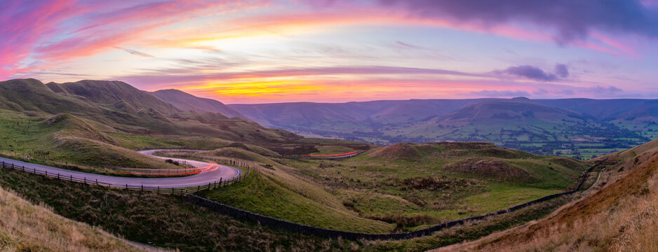 View of landscape and trail lights in the Hope Valley at sunset, Peak District National Park, Baslow, Derbyshire, England, United Kingdom