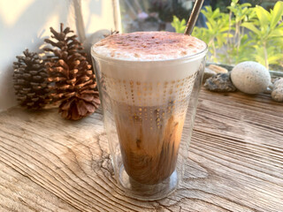Iced cappuccino coffee drink on wooden table in  cafe