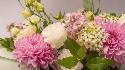 Bouquet of flowers with pink roses, chrysanthemum and freesia flower in a vase isolated on a white background.