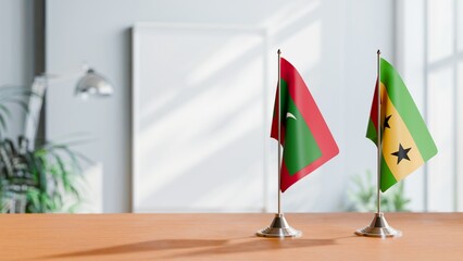 FLAGS OF MALDIVES AND SAO TOME ON TABLE