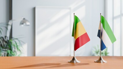 FLAGS OF MALI AND SIERRA LEONE ON TABLE