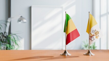 FLAGS OF MALI AND VATICAN ON TABLE