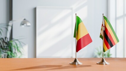 FLAGS OF MALI AND ZIMBABWE ON TABLE