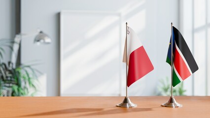 FLAGS OF MALTA AND SOUTH SUDAN ON TABLE