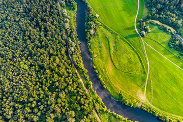 Earth landscape from the air, view of forest and field separated by river