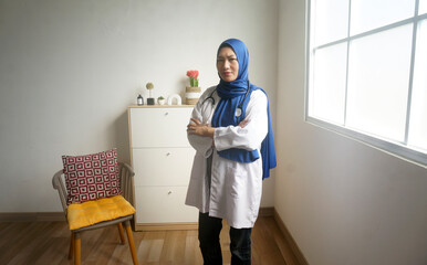 Potrait Of Young Asian Muslim Woman Doctor Standing In Folded Arms With Confident In Hospital