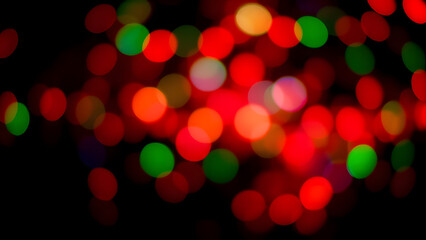 Abstract colorful bokeh with vivid red, green, and blue lights floating on a black grad