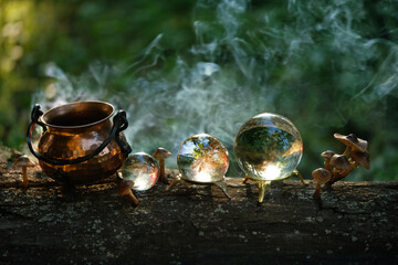 witch copper cauldron and crystal balls in forest close up, abstract dark natural background. occultism, magic ritual, witchcraft. wicca, esoteric spiritual practice. fairytale, mystery image