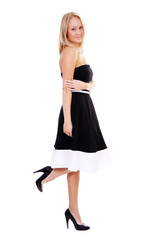 Portrait of a young beautiful blonde girl in a black dress