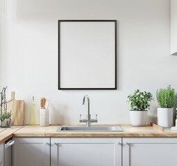A minimalist kitchen with a black framed empty poster above the sink with a wooden countertop and white cabinets