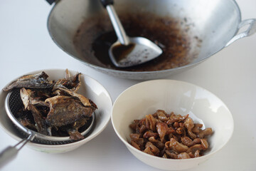 Crispy fried food on bowls after cooking with burnt used oil in pan. Concept, The oil used for frying food should not be reused because it contains carcinogens. Health care                 