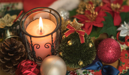 lit candle and various Christmas decoration objects in full screen