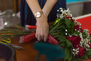 in a flower shop, the process of making a bouquet,