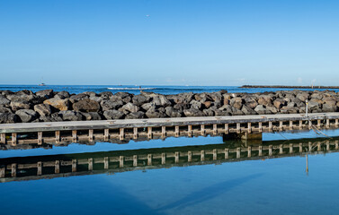Harbor Pier Silhouetted in the Clear Blue Water at Waikiki, Hawaii.