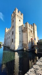 Sirmione, Italy - November 6, 2024: Scaliger Castle, the historic center of Sirmione, on the shores...