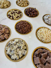 various sweet additives to ice cream in a cafe