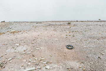Thames river coast with abandoned, old tire