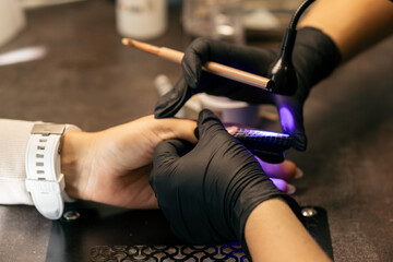 View of the process of a manicure being performed by a master