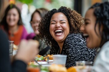 A group of women enjoy sharing laughter and meals at a lively dining setting, capturing the spirit of friendship and joy in social gatherings.