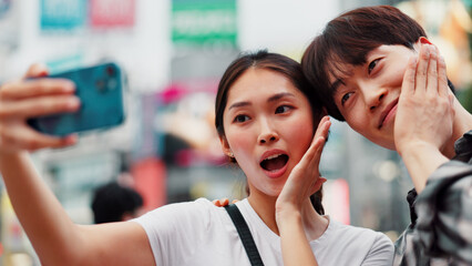 City, selfie and wow with couple on street together in Japan for bonding, love or tourism. Happy, photograph and surprise of Japanese woman with man in urban town for holiday, travel or vacation