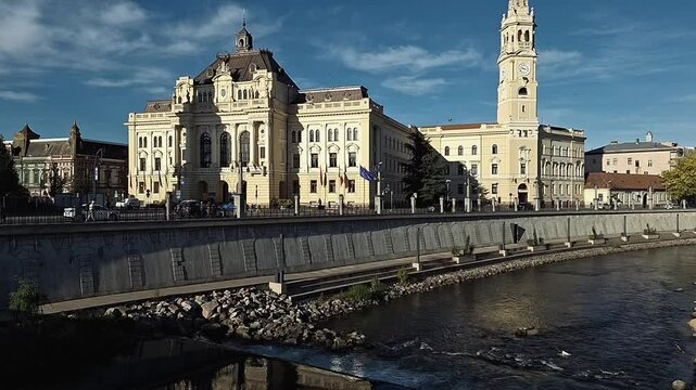 The morning sun highlights the architecture of Oradea City Hall.