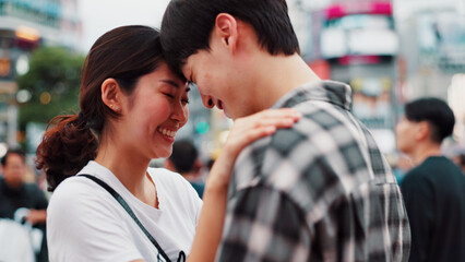 Fototapeta premium Love, happy couple and forehead touch in city for support, loyalty and commitment on vacation. Japanese man, woman and embrace for romantic relationship, connection and trust partner outdoor on date