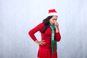 indonesia woman expression wearing red sweater party wear with Santa hat and scarf celebrating...