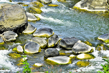 Beautiful, aesthetic and artistic river rocks with clear water in rural Asia Indonesia	