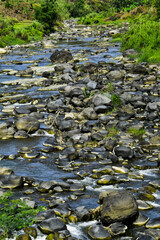 Beautiful, aesthetic and artistic river rocks with clear water in rural Asia Indonesia	