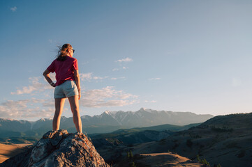 Fototapeta premium Woman Admiring Mountain Landscape at Sunset