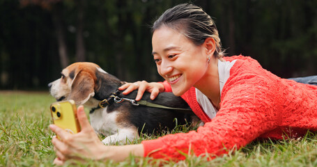 Selfie, nature and woman relaxing with dog for memory, social media or online post in woods. Happy,...