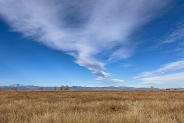 Autumn landscape of meadow, lenticular clouds, and the Front Range of the Rocky Mountains, Colorado, USA