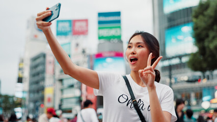 Japanese woman, selfie and peace sign in city with live streaming of vlogger for content creation....