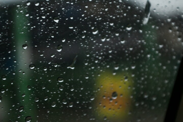 Drops of rainwater on the windshield of a car forming designs and textures. Graphic resources.