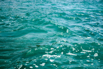 An abstract background of seawater flow under light exposure