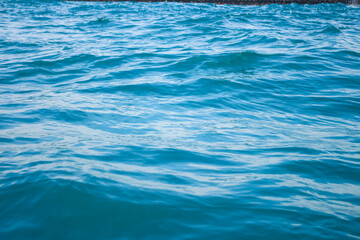 An abstract background of seawater flow under light exposure