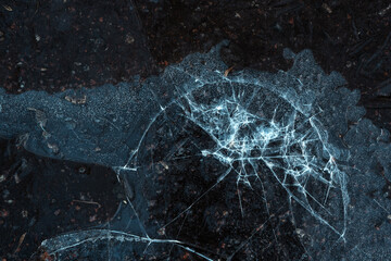 Cracked ice pattern on a frozen surface, highlighting the intricate details of winter nature.
