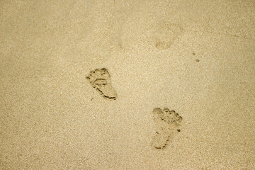 white beach sand texture background, footprints in the sand