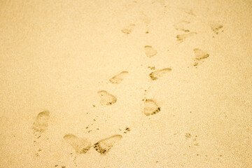 white beach sand texture background, footprints in the sand