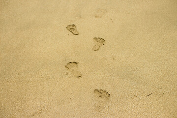 white beach sand texture background, footprints in the sand