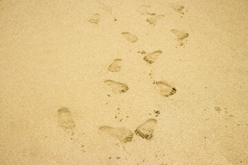 white beach sand texture background, footprints in the sand