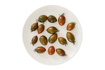 Tomatoes in a ceramic plate isolate on white background. Variety vegetables in rural bowl. Top view.