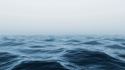 Fototapeta premium Experience the serene beauty of calm ocean waves blending into a misty horizon. A perfect backdrop for relaxation and inspiration.