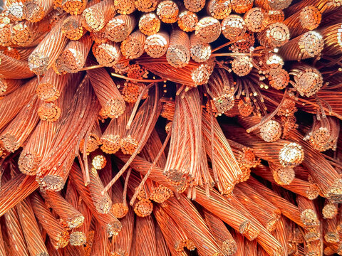 Detailed close-up of a heap of frayed and cut copper wires with visible strands and natural oxidation.