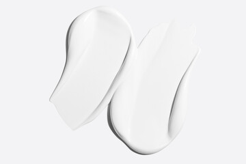 Smears of white cosmetic cream on a light background